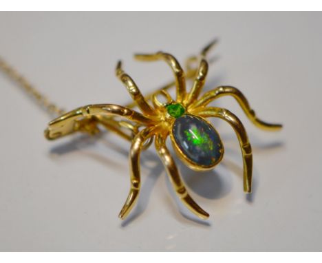 Black opal spider brooch with open back, collet-set with a black opal and demantoid garnet, in gold, with safety chain and pi