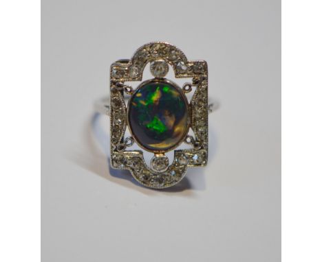 Art Deco period black opal and diamond plaque ring, set with an oval black cabochon opal and various old-cut diamond brillian