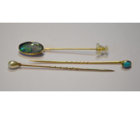 9ct gold opal scarf pin and two others in 9ct gold, set with a turquoise and pearl, 2.1g gross.  (3)The opal is 12.5mm x 6mm.
