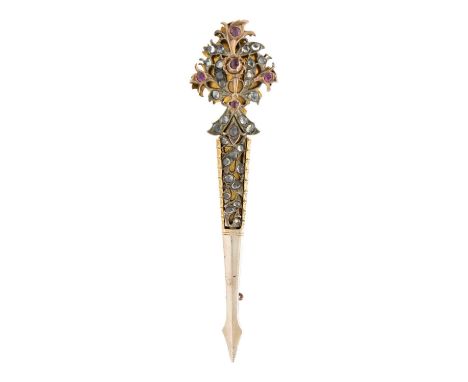 An Indian gilt metal turban pin. With ruby and white paste, length 11cm, width 2.7cm.