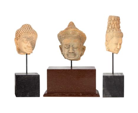 Three Cambodian/Thai Buddhist pottery heads. Each mounted on a stand, heights 30, 28 and 27cm. (3)