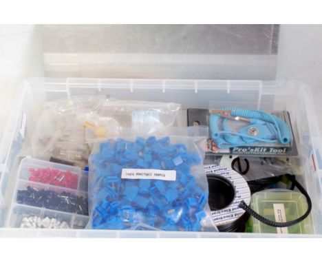 Two plastic boxes containing variety of tools and components from a modeller's workshop, including many electrical components
