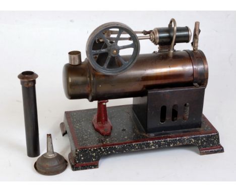 An early 20th century tinplate stationary steam engine comprising of tin housed boiler, with single cylinder fitted with slip