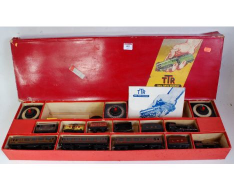 A Trix Twin Railway long red set box containing freelance LMS red 0-4-0 engine and tender No. 5670 (FG), 3 shorter bogie coac