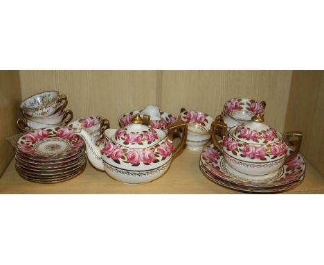 An early 19th century |Spode style part teaset decorated with roses on a white guard and parcel gilded comprising a teapot, m