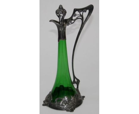 WMF, an Art Nouveau white metal mounted green glass claret jug and stopper, with elongated handle and swimming maiden decorat