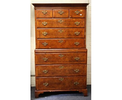 A George II style burr walnut veneered and featherbanded chest on chest, the moulded cornice over three short and three long 