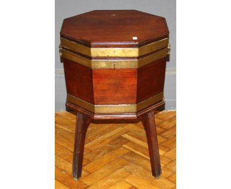 A George III mahogany and brass bound octagonal wine cooler the rising top over a fitted interior, raised on chamfered square