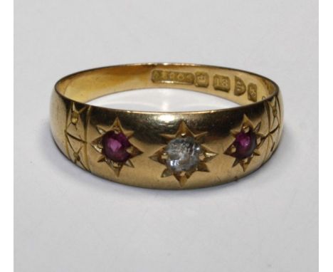 A three stone, gypsy set ruby and diamond ring, hallmarked 1906, Chester, size P 1/2