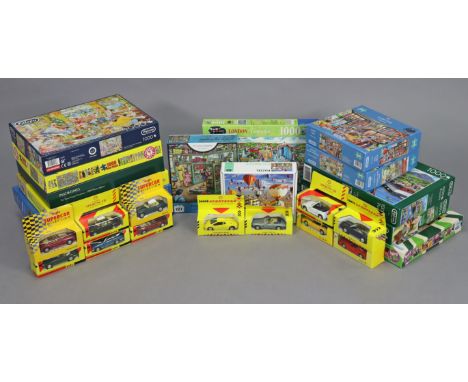 Eight Maisto “Supercar Collection” scale models, &amp; fourteen various jigsaw puzzles. 
