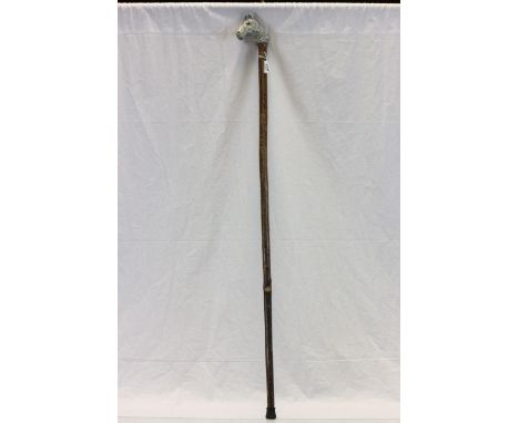 Long walking stick with a horse head handle