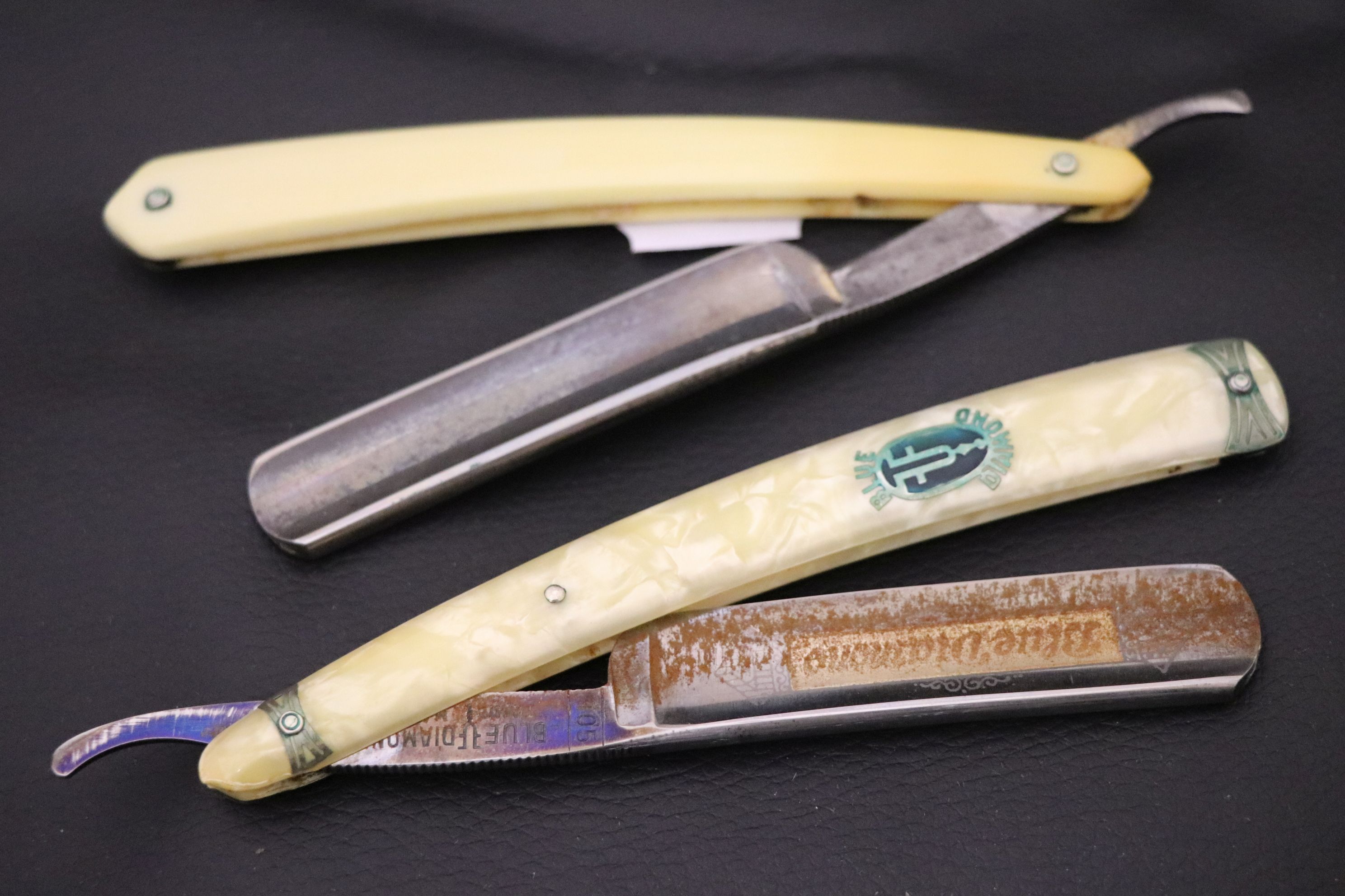 Two vintage cut throat Razors and a sharpening stone