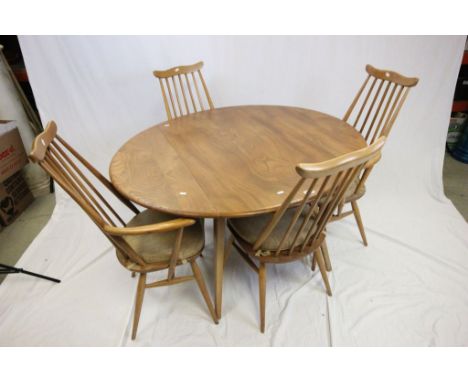 Ercol Pale Elm Circular Drop Flap Dining Table on Four Square Tapering Legs together with Four Ercol Stickback Dining Chairs 