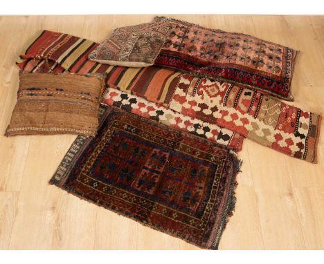 An oriental light red ground rug with three central diamond motifs and various birds decorating the flower strewn central fie