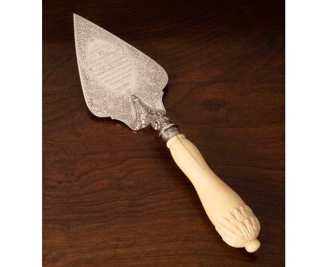 An Edwardian silver engraved presentation trowel with turned and carved ivory handle with acanthus pommel motif inscribed: “P