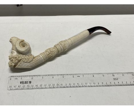 A vintage large meerscham pipe with a rams head bowl &amp; amber mouth piece 