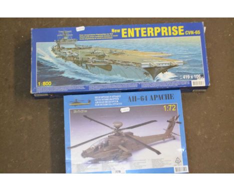 Two boxed scale models of a battleship and a helicopter