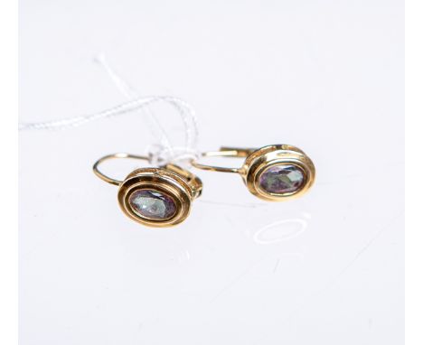 Paar Ohrringe 333 GG, besetzt m. einem ovalen Amethyst, Gewicht ca. 1,79 g.