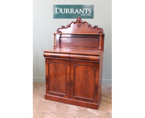 A mid 19th Century chiffonier with shaped back and shelf on turned supports, 39" x 19" x 60"