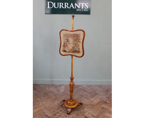 A mid Victorian maple wood pole firescreen, original needle work panel to screen on a tapering mellon shaped column on a circ