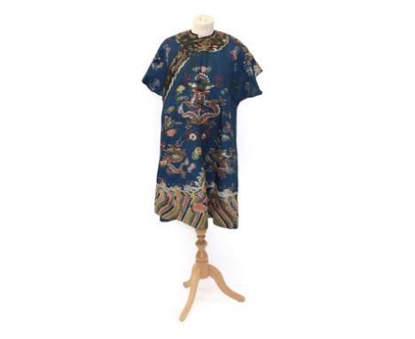 An Early 20th Century Chinese Blue Silk Robe, embroidered with dragons to the front and back, floral motifs and a wave hem, b
