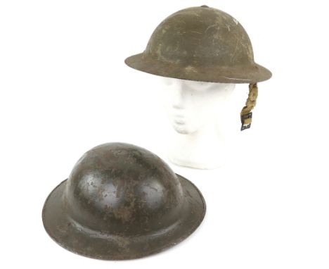 Props - Two WWI tin helmets used in various productions such as The Fighting 69th starring James Cagney, one inscribed 'John 