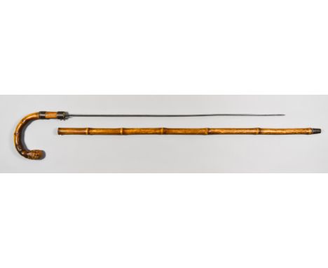 A Victorian Sword Stick, in the form of a walking stick, 25ins bright steel double edged blade, brass fittings with blade rel