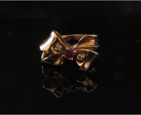 A gold ruby and diamond ribbon bow ring. Size M, 4.4g