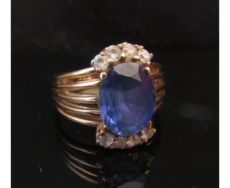 A gold ring with oval sapphire in multi split shoulders, stamped 9ct. Size K, 5g