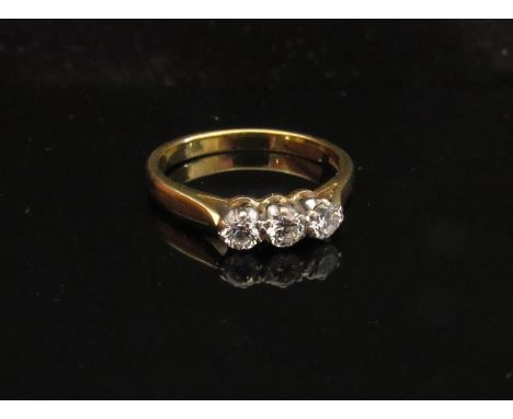 An 18ct gold three stone diamond ring .30ct total approx. Size M/N, 3.2g