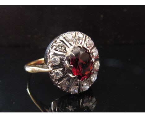 A ruby and diamond cluster ring on 18ct gold shank. Size S, 5.5g