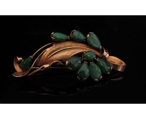 A gold leaf form brooch set with nine jade stones, stamped 14k, 6.2g