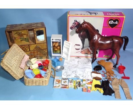 A boxed Sindy horse, with saddle, bridle, nose bag, rosette, helmet, bucket, broom, comb, brush and instructions and a fridge