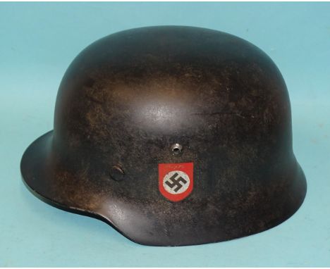 A WWII-era Nazi German SS M35 helmet, with SS rune and swastika decals, the leather liner ink-stamped Karl Heisler Berlin C2 