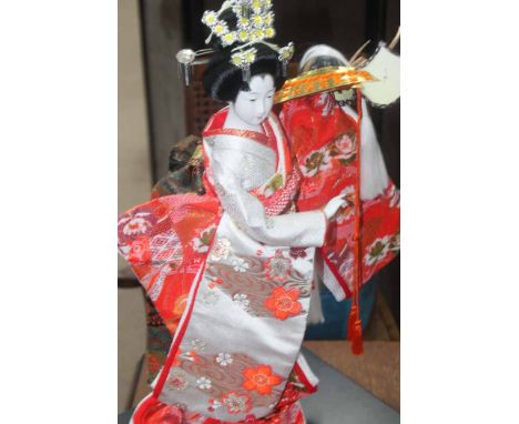 MODERN JAPANESE COMPOSITION HEADED FIGURE OF A GEISHAmodelled holding a samuri helmet; together with a collection of Japanese