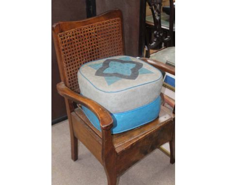 CANE BACKED COMMODE ARMCHAIR TOGETHER WITH A LEATHER FOOT STOOL