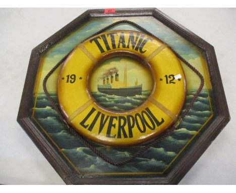 A reproduction wooden plaque depicting the Titanic 1912 at sea with a raised image of a lifeguard ring 
