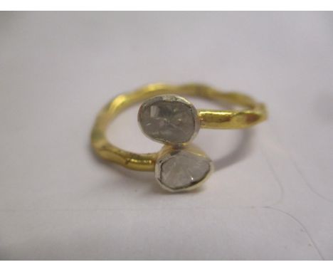A silver gilt ring set with two crossover diamonds 