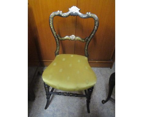 A Victorian ebonized and mother of pearl inset bedroom chair, overstuffed seat, splayed front legs and sabre reverse 