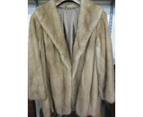 A vintage light brown mink hip length coat with brown satin lining with an embroidered name Yvonne Saunders, having a shawl c