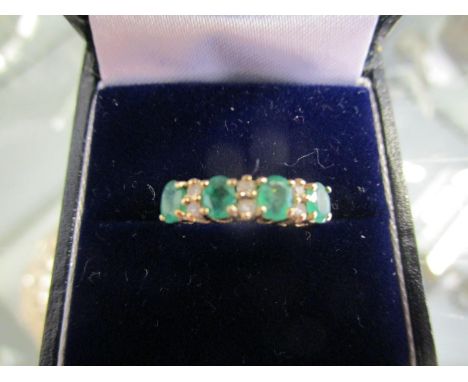 9ct yellow gold ring set with oval-cut emeralds and round-cut diamonds, boxed 