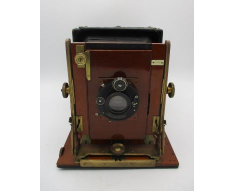 A Compur Tropical cased folding camera by Houghtons Ltd, London, in teak wood with brass fittings, encased in a Moroccan leat
