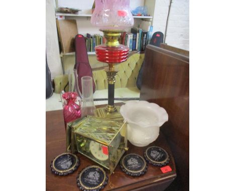 A Victorian oil lamp with ruby glass reservoir and pink glass shade A/F and another, together with a ruby glass vase with twi