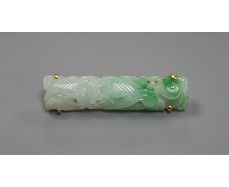   A 14k yellow metal and carved jade set bar brooch, 41mm,gross 6 grams.