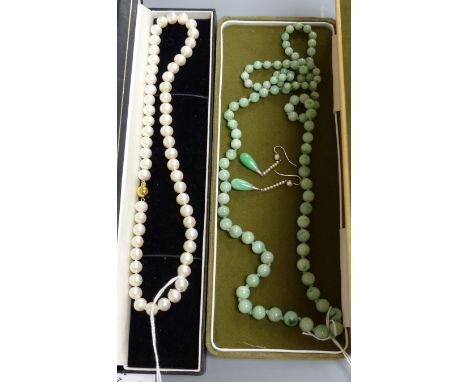   A single row uniform cultured pearl necklace with 9ct gold ball clasp, a graduated jade bead necklace and a pair of jade an