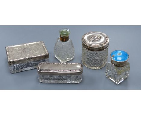   A Victorian silver mounted glass toilet jar, 98mm, four other silver mounted toilet jars, including one with enamel(a.f.).