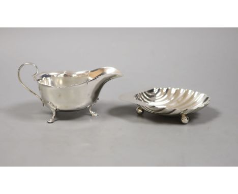   A George V silver butter shell, 13.2cm and a similar sauceboat by Mappin &amp; Webb,160 grams.