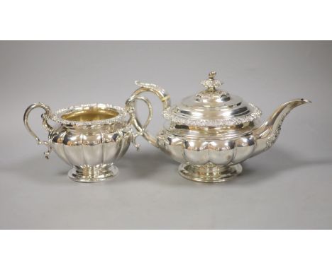   A large Georgian silver teapot, marks rubbed, with an associated twin handled sugar basin, Sheffield, 1864 by Henry Wilkins