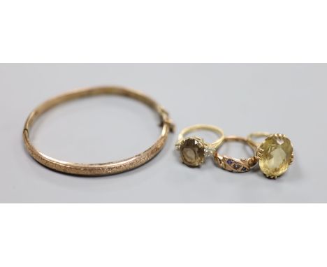   Three assorted 9ct and gem set rings and a 9ct gold hinged bangle,gross 18.1 grams.