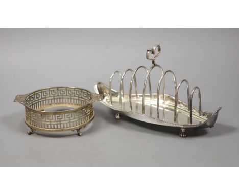   A late Victorian silver seven bar toastrack, with shaped ring handle, on paw feet, Josiah Williams &amp; Co, London, 1896?,